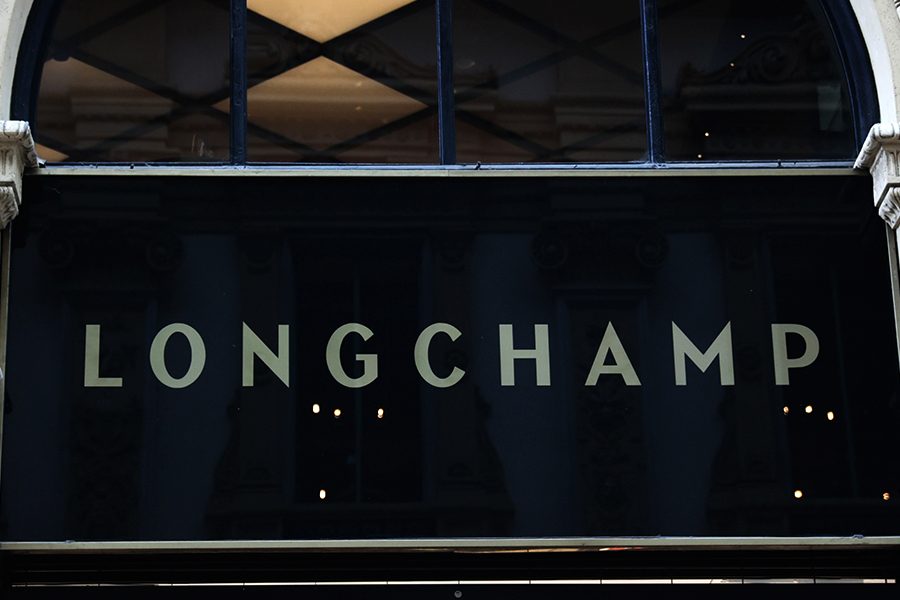 A closeup of the Longchamp logo at its store front in Paris, France